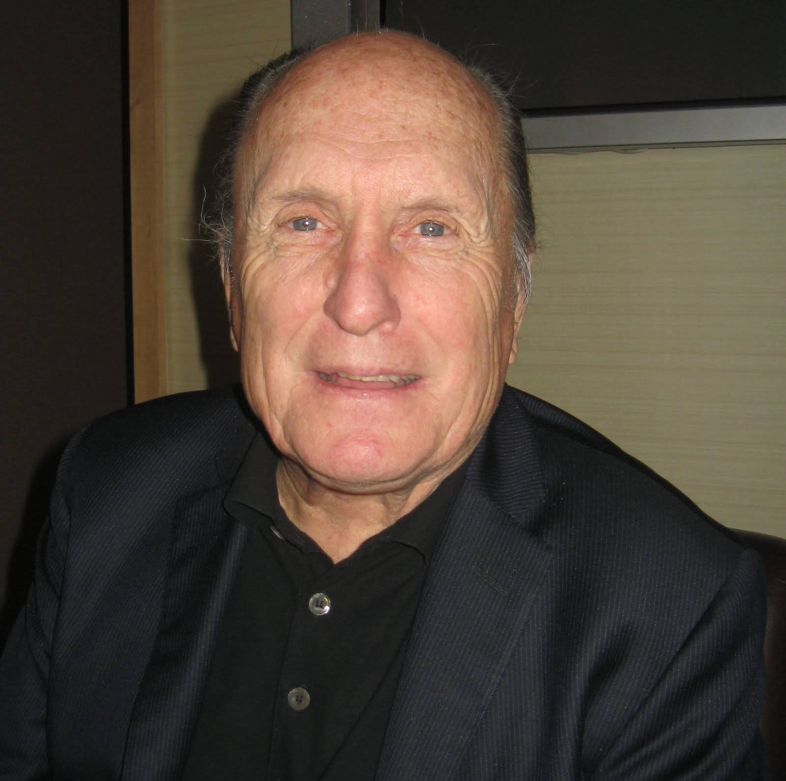 Legendary American Actor And Filmmaker, Robert Duvall Smiling For The Camera Wallpaper