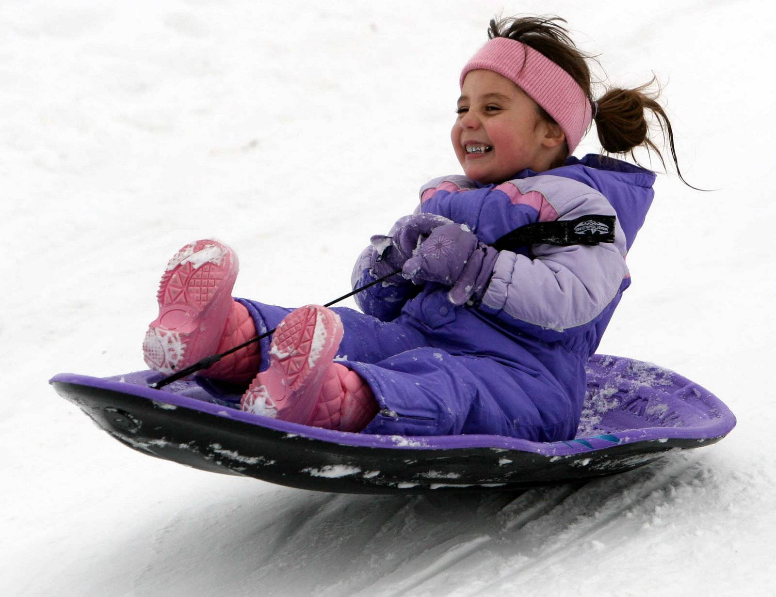 Little Girl Happy Sledding Wallpaper