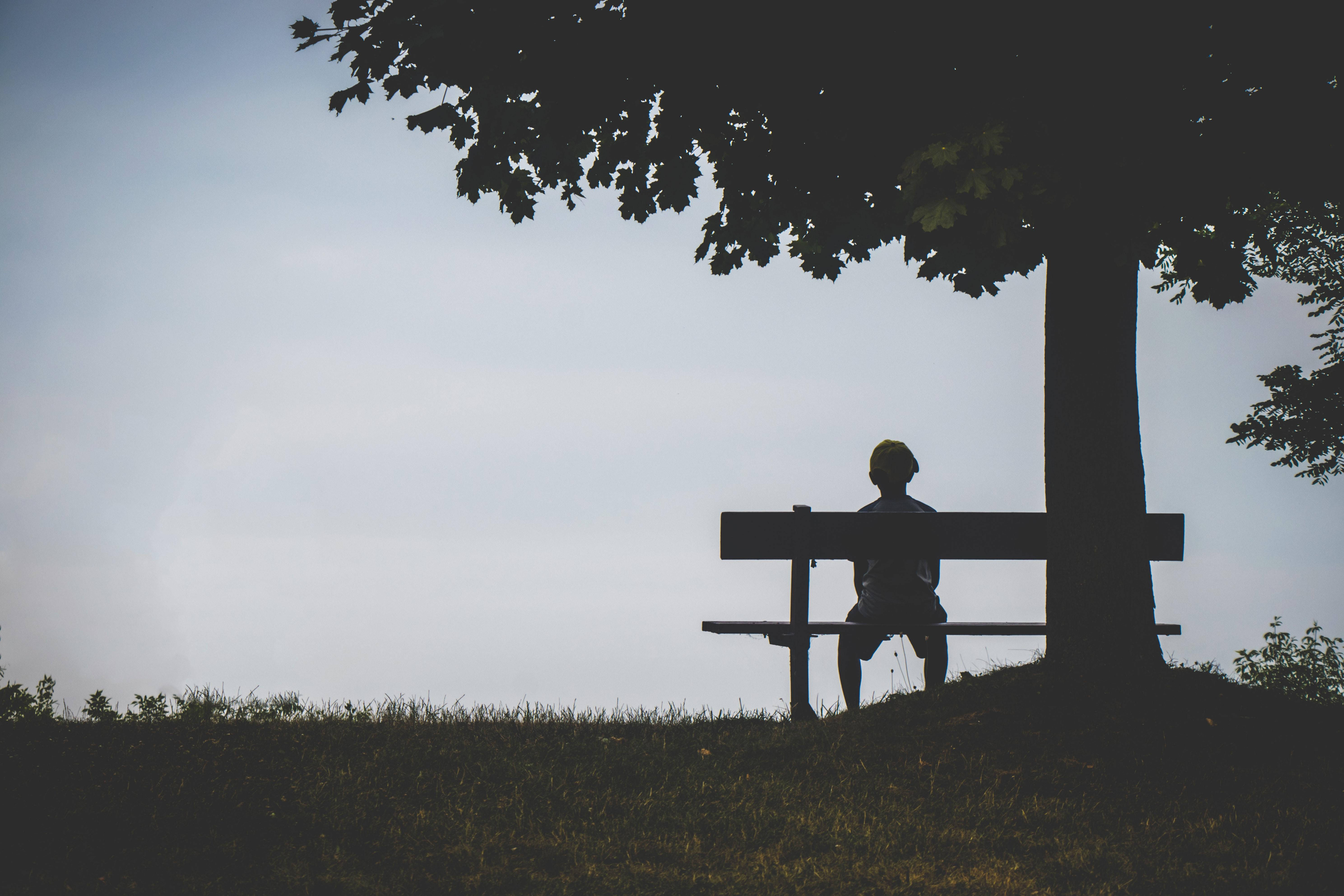 Lonely Boy On Bench With Phone Wallpaper