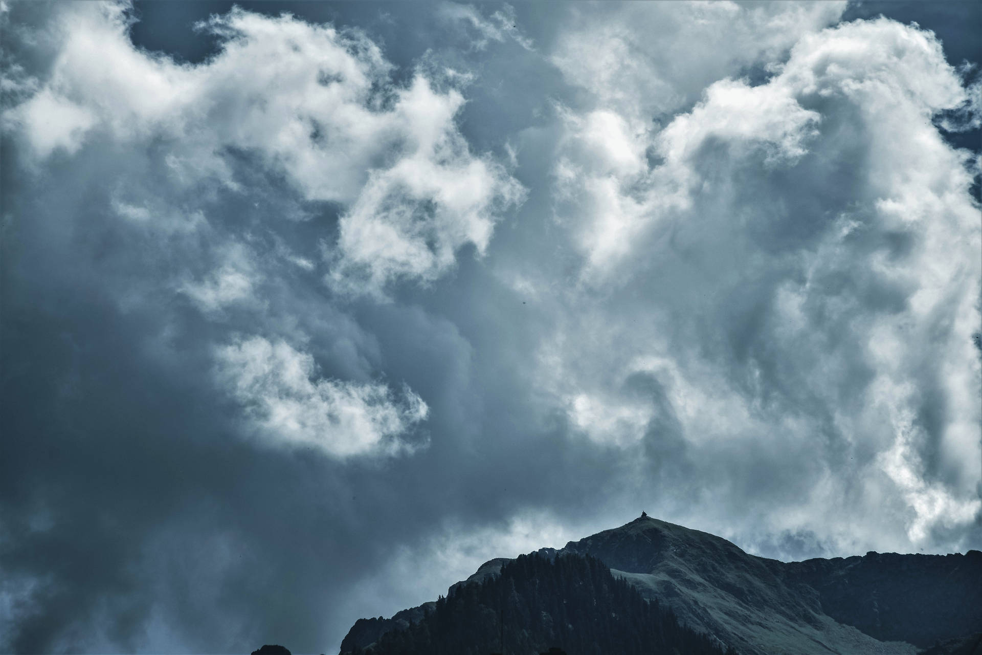 Magnificent Cumulonimbus Clouds Over Majestic Mountain Wallpaper