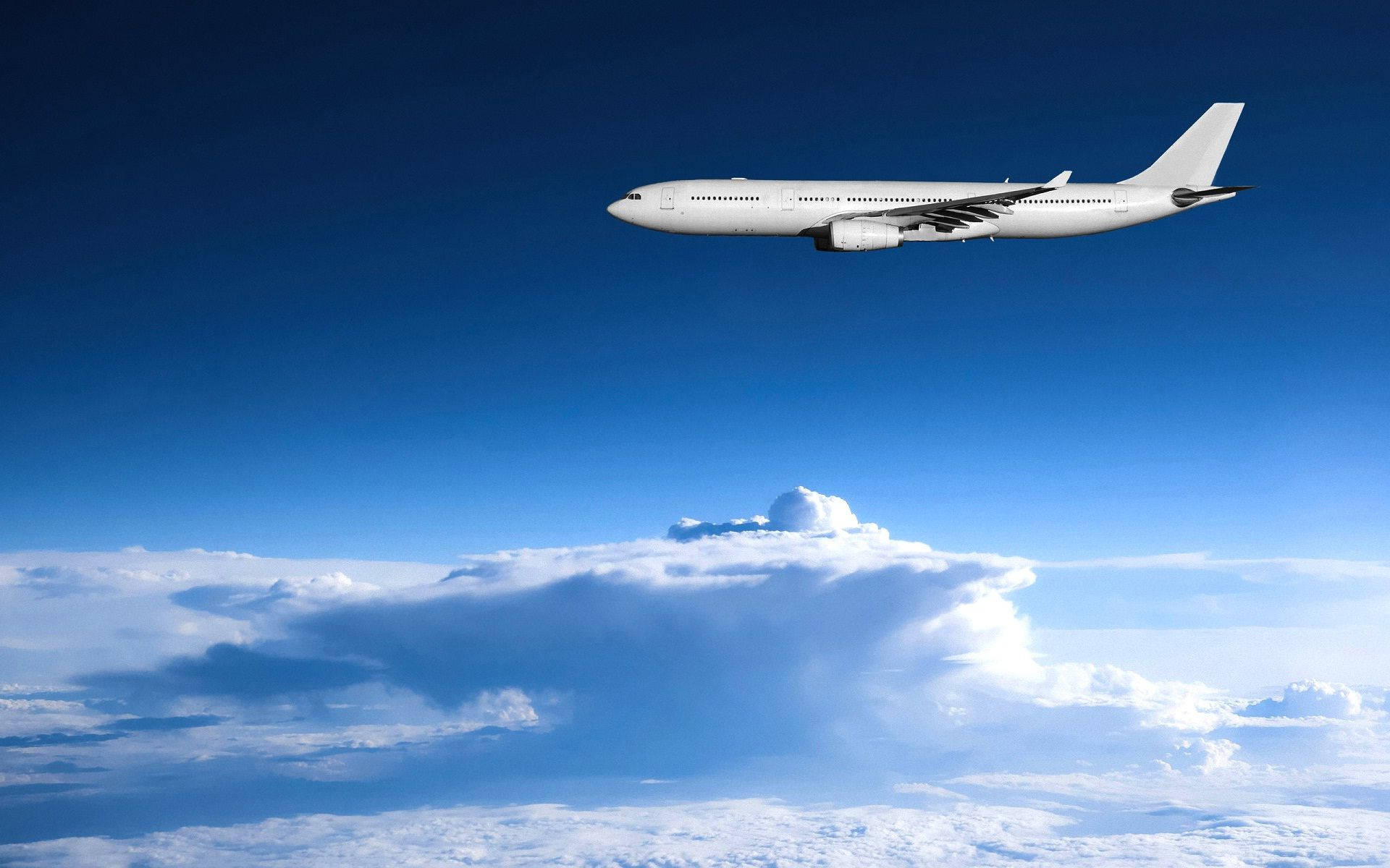 Magnificent White Airplane Soaring Through The Sky Wallpaper