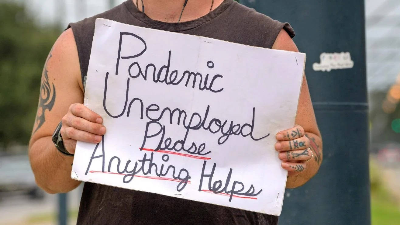 Man Holding Unemployment Signboard During Pandemic Wallpaper