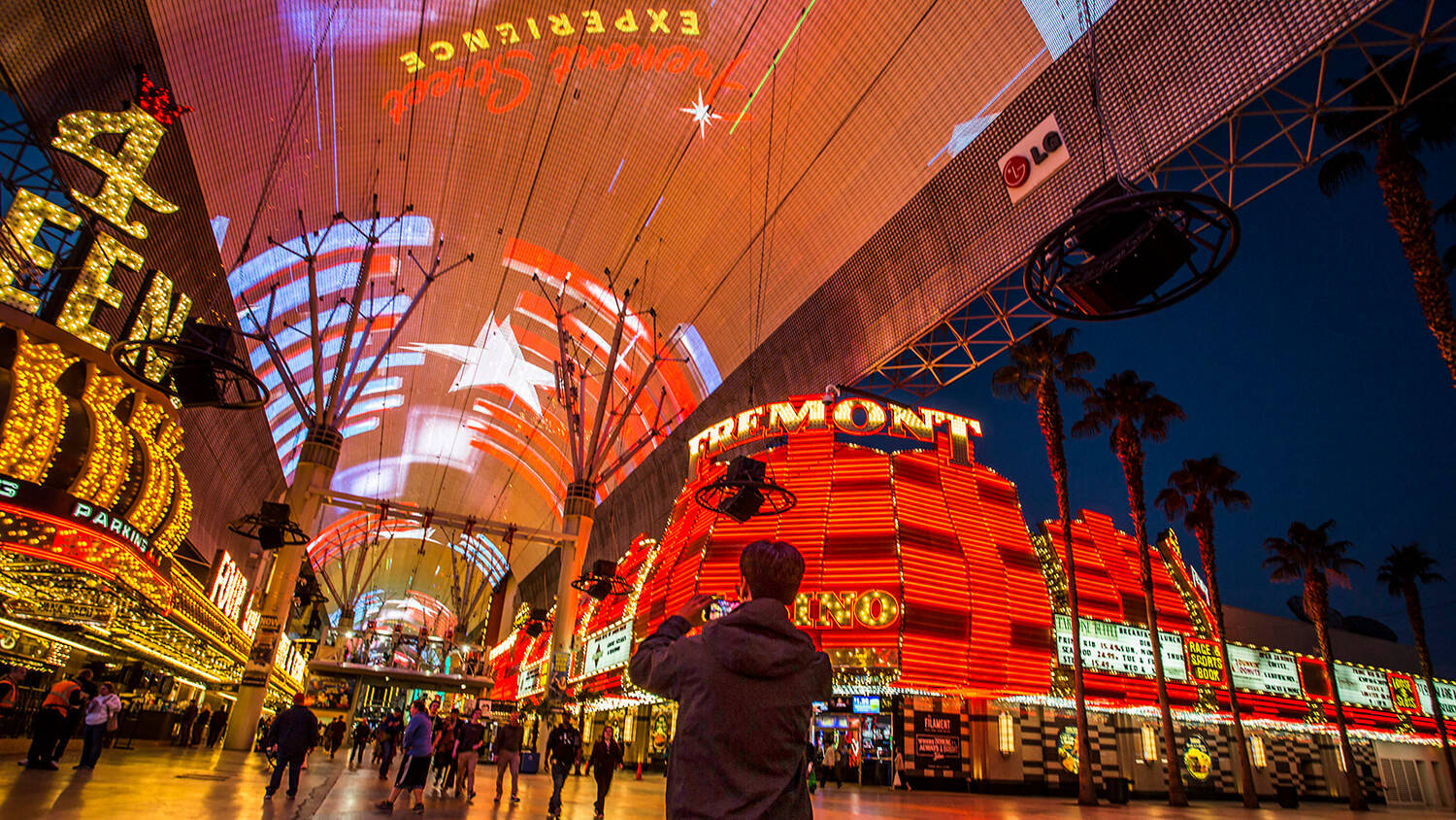 Man Taking Pictures Fremont Street Wallpaper