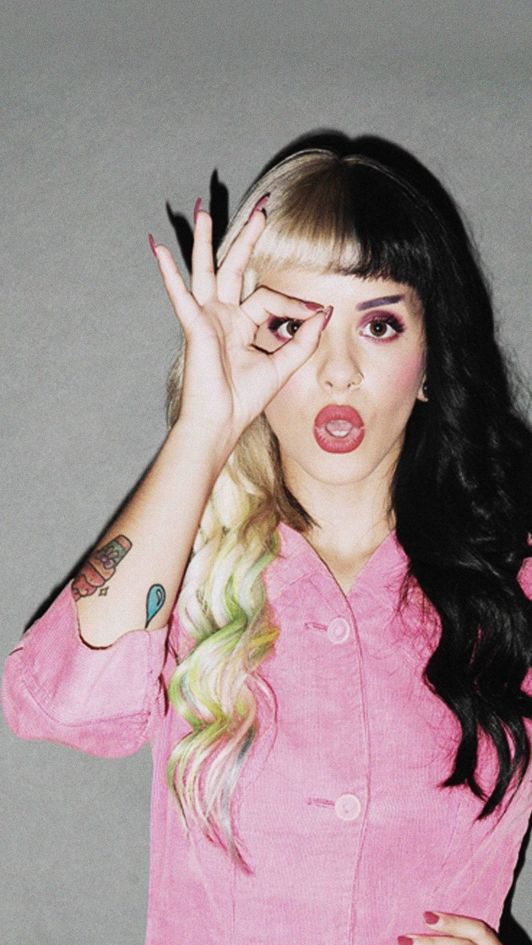 Melanie Martinez Striking A Pose With Her Signature Hand Sign Wallpaper