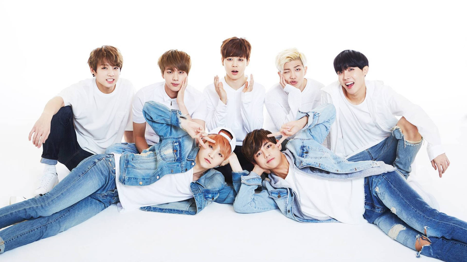 Members Of The K-pop Group, Bts, In White And Denim Wallpaper