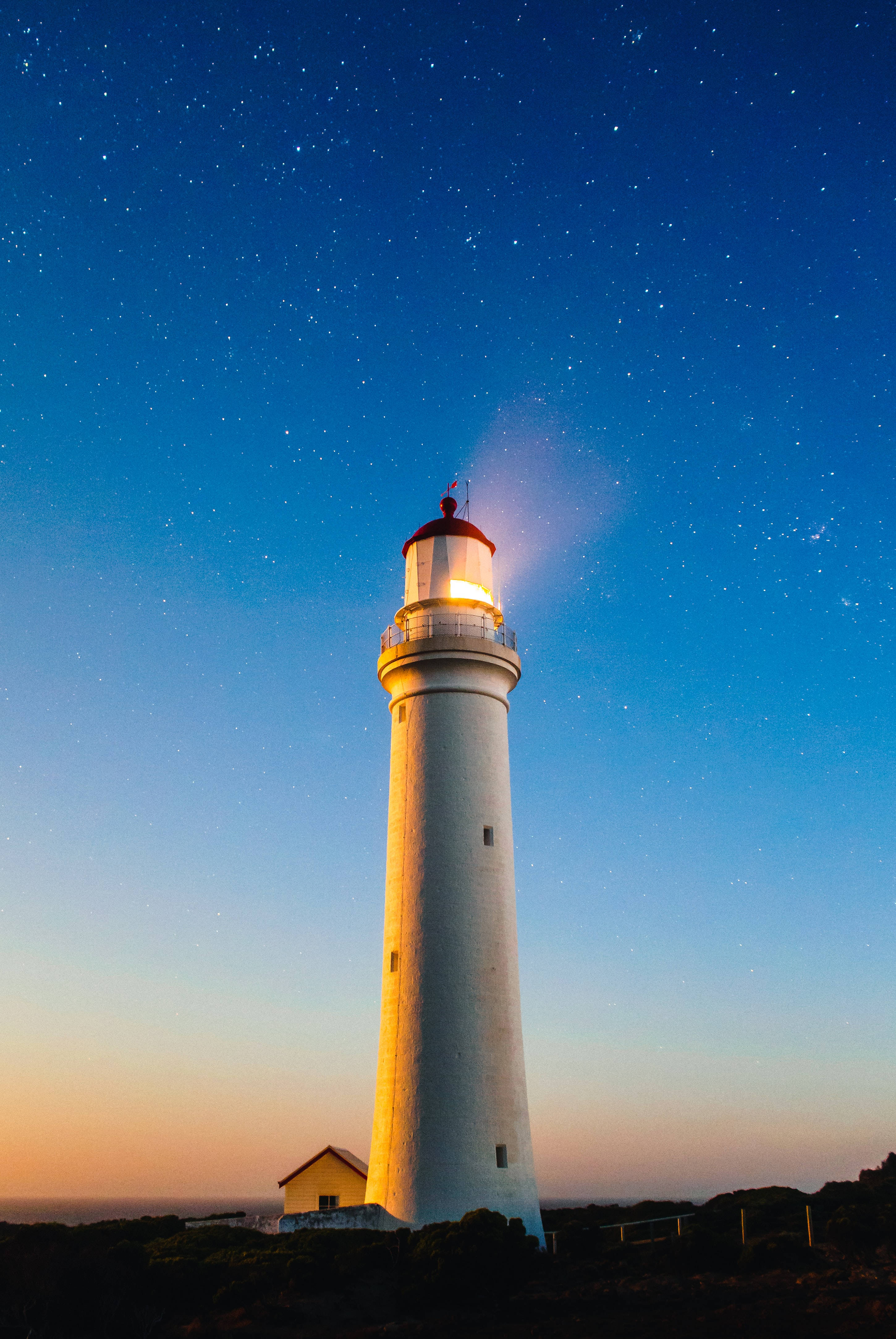 Mesmerizing 4k Ultra Hd Phone Wallpaper Of A Lighthouse Under The Blue Sky Wallpaper