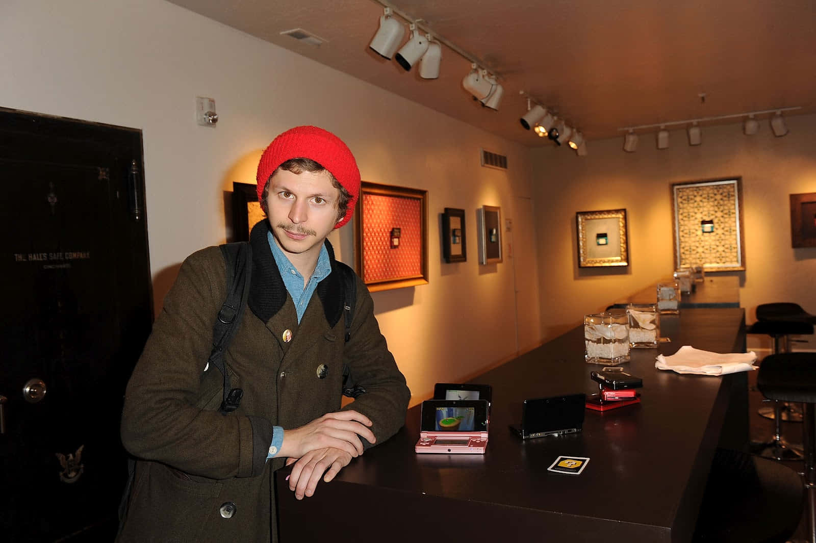 Michael Cera Smiling Against A Blue Backdrop Wallpaper