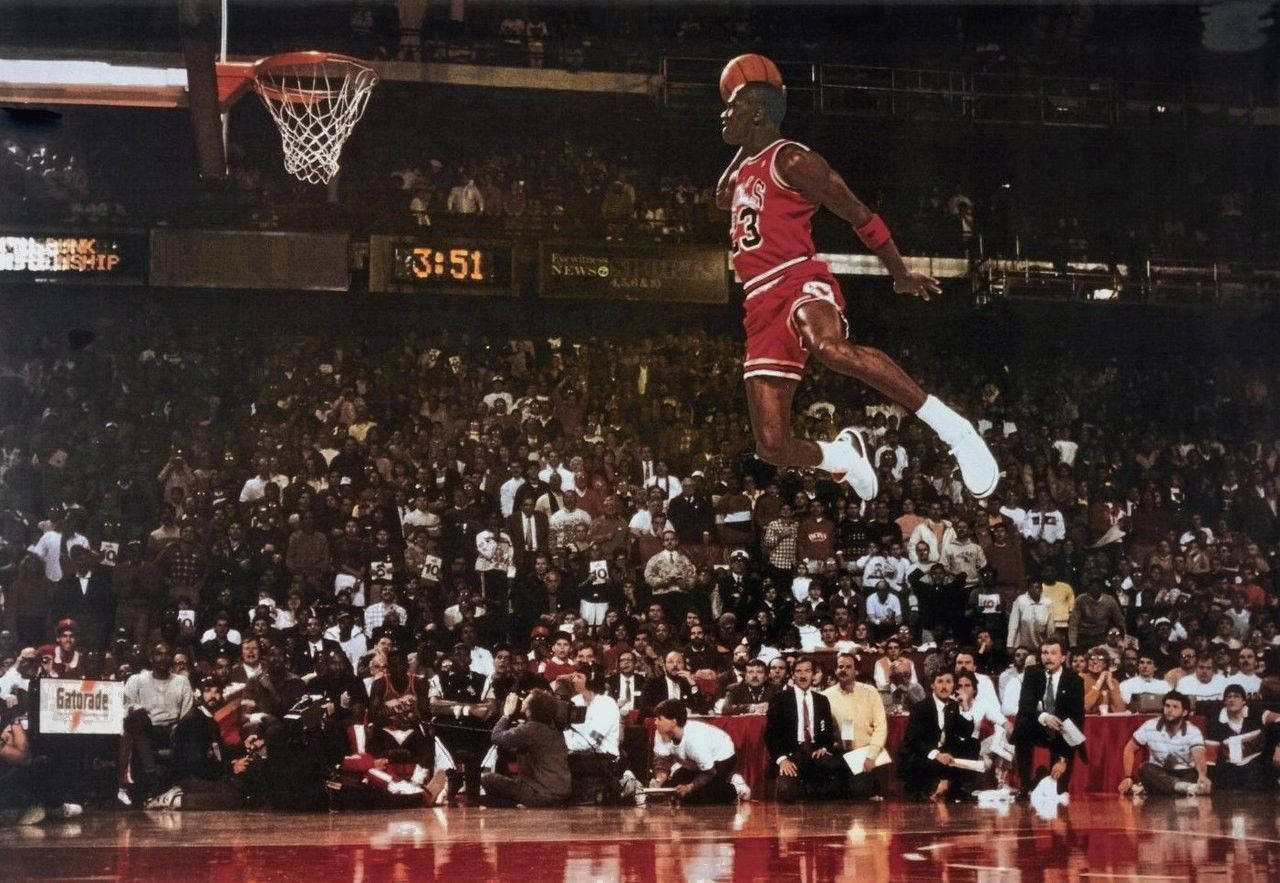 Michael Jordan Reaches Epic Heights With A Flying Slam Dunk Wallpaper