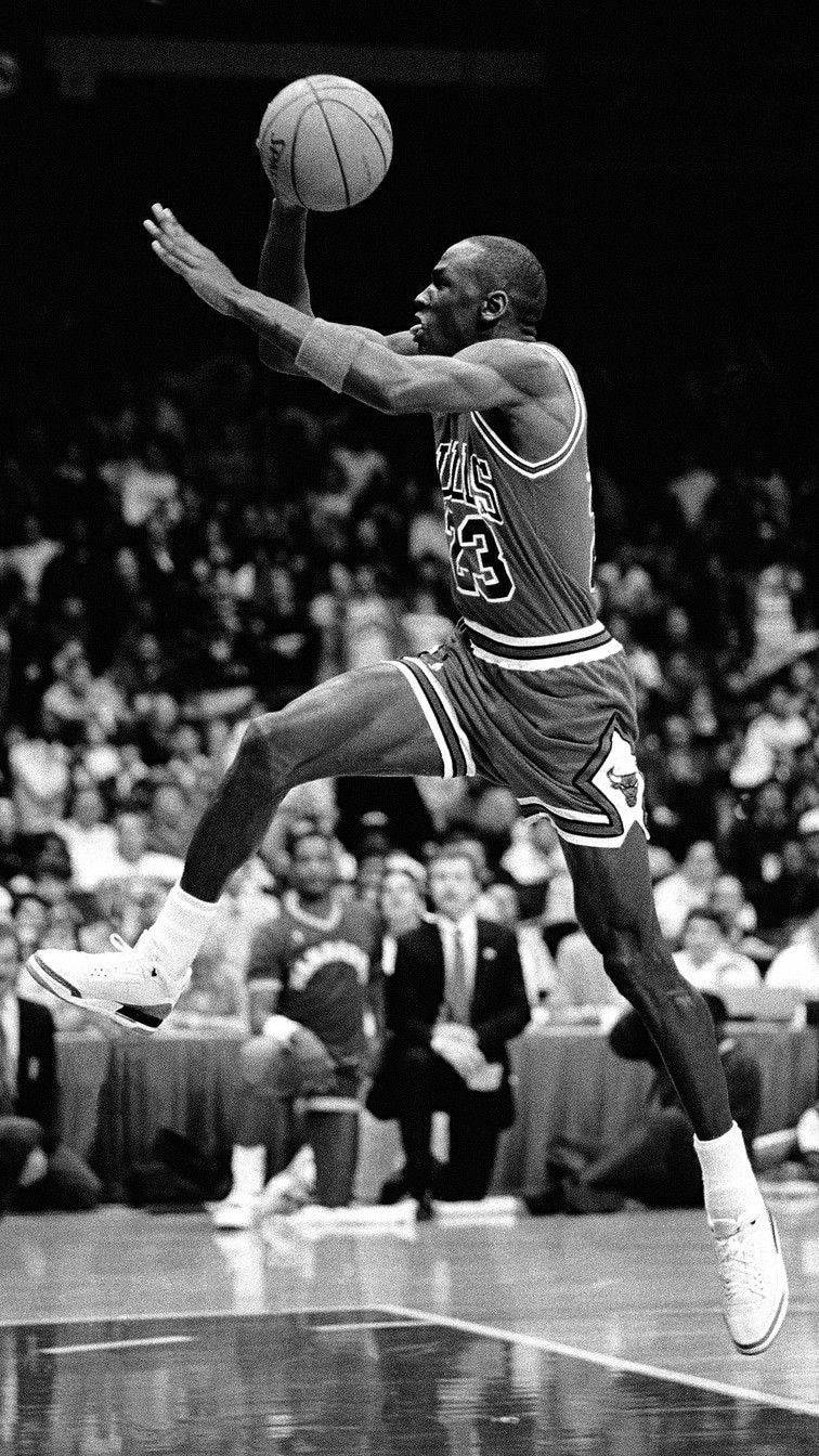Michael Jordan Taking Flight In An Iconic Moment Wallpaper
