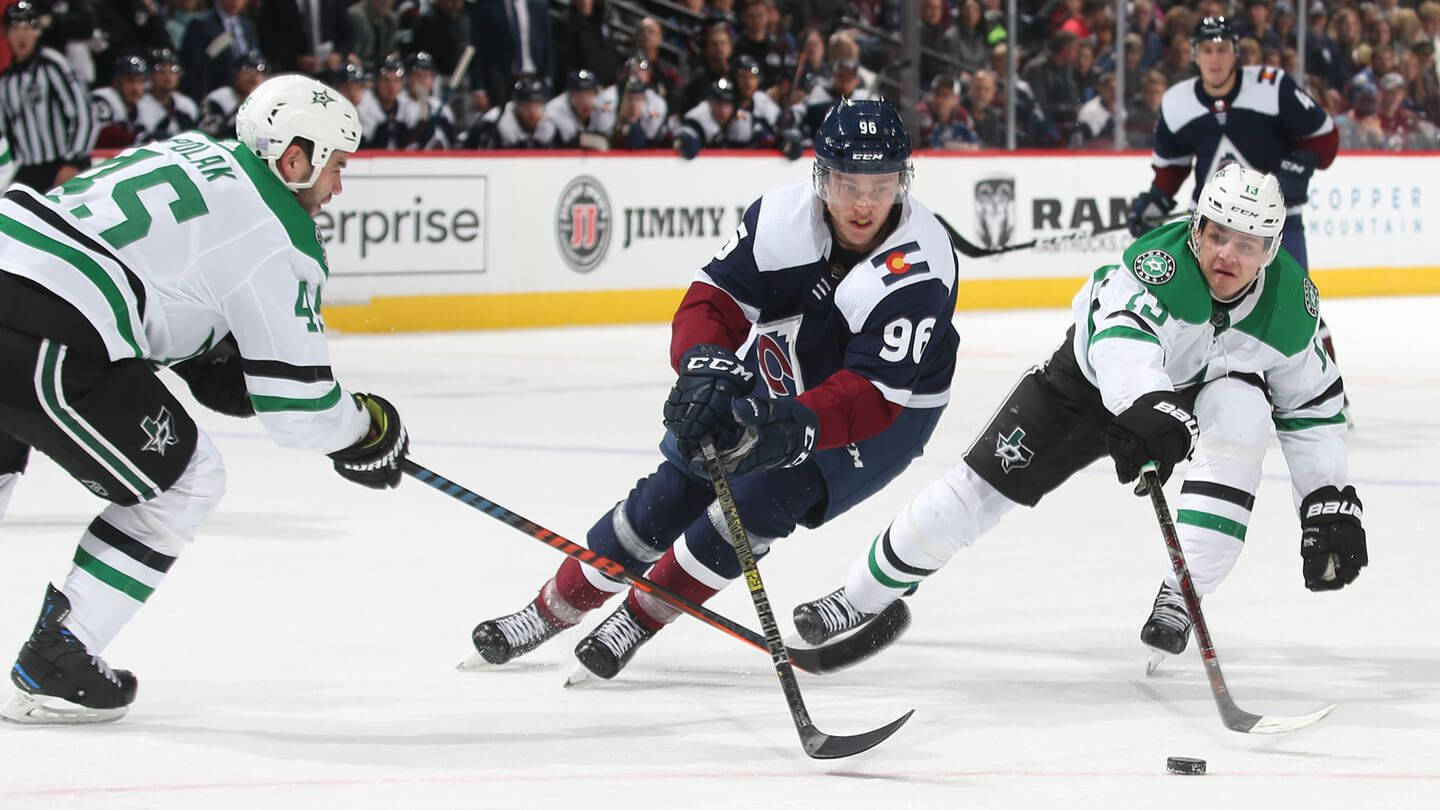 Mikko Rantanen Dribbling Hockey Puck Against Dallas Stars Players Wallpaper