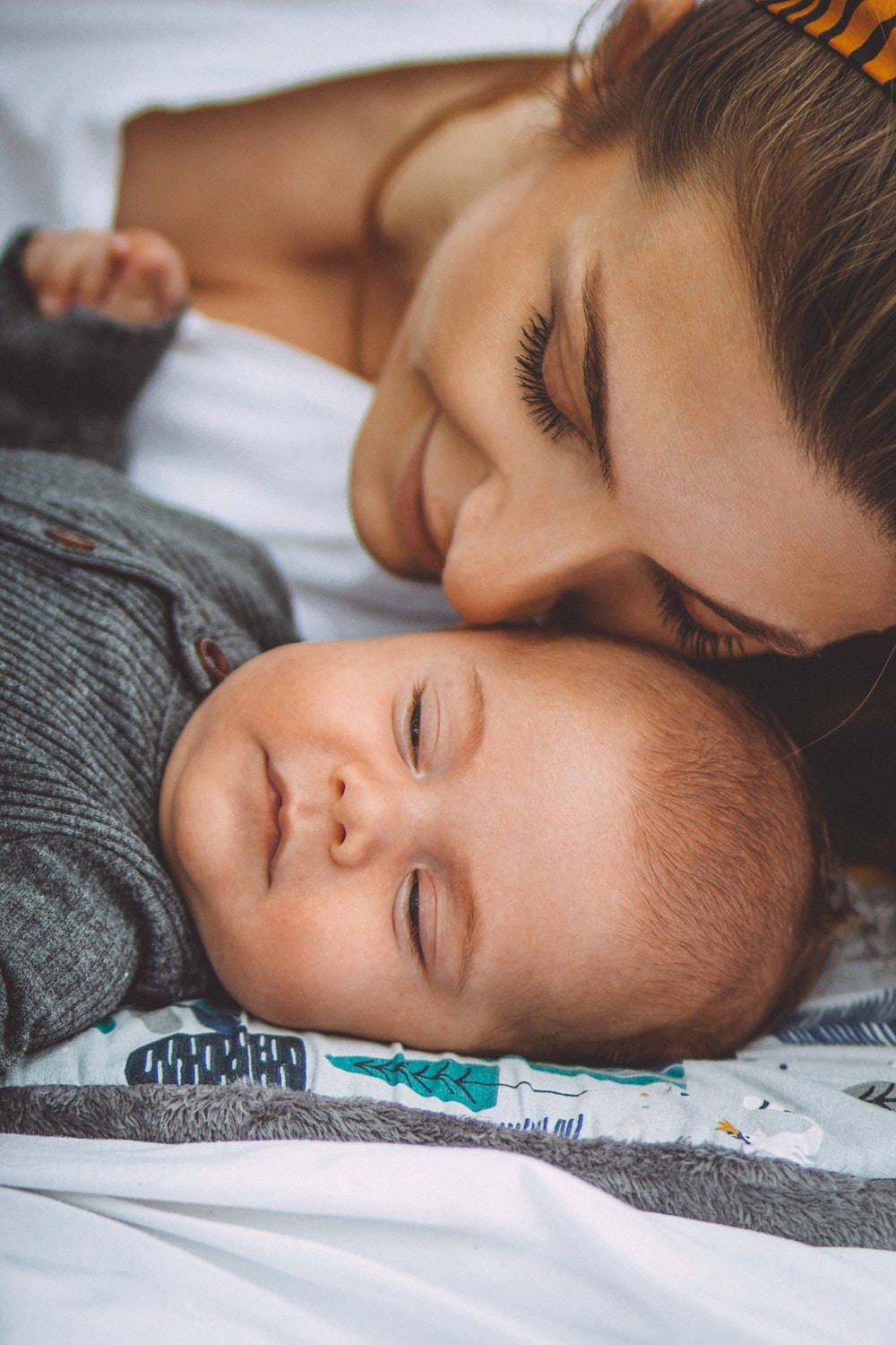 Mom And Son Smiling And Sleeping Wallpaper