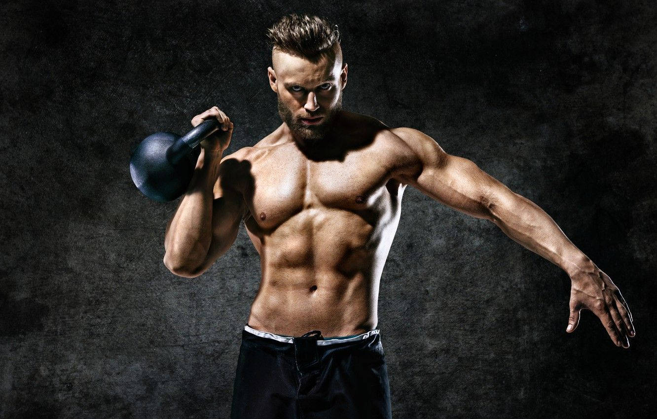 Muscle Man Lifting A Kettlebell Wallpaper