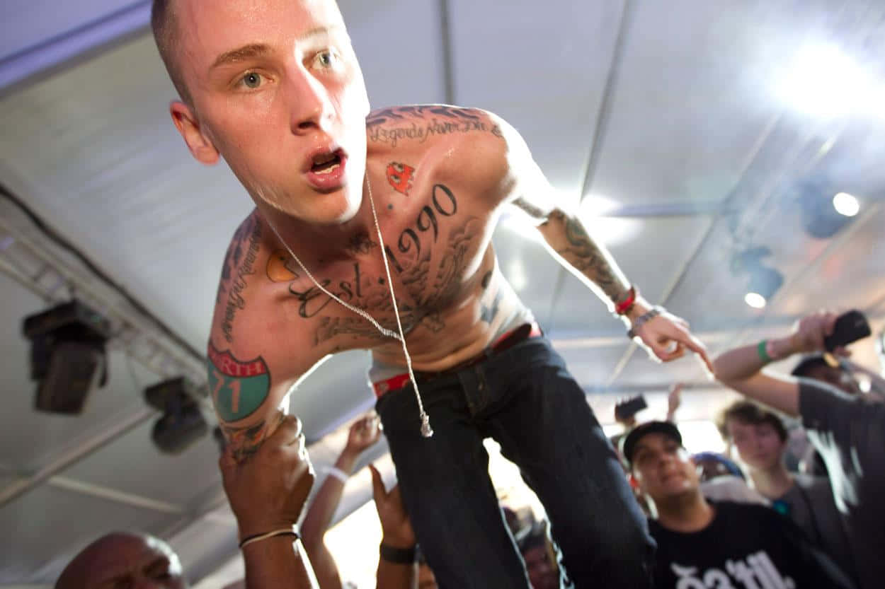 Music Artist Mgk Performing Onstage Wallpaper