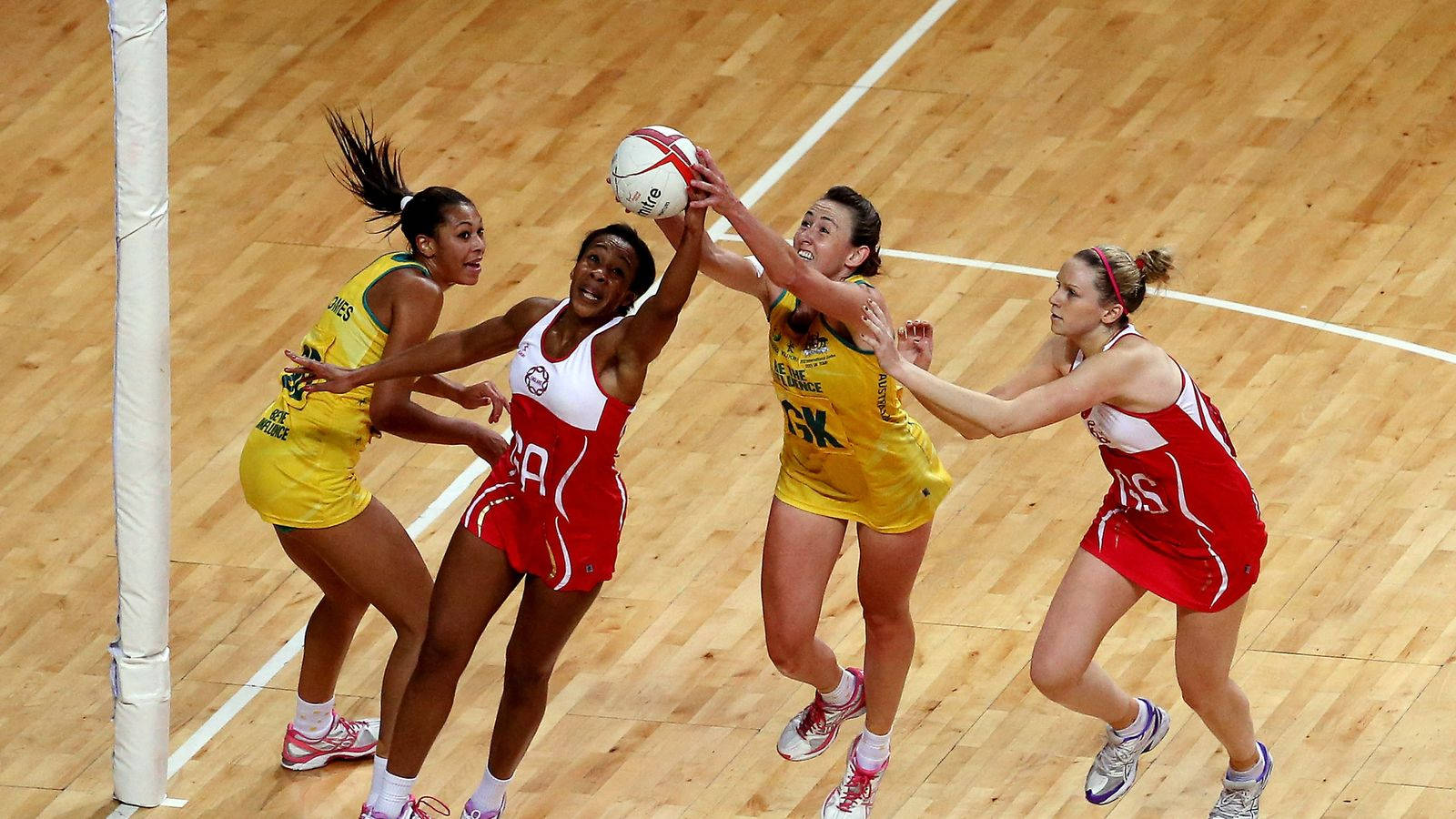 Netball Game Two Teams Grabbing Ball Wallpaper