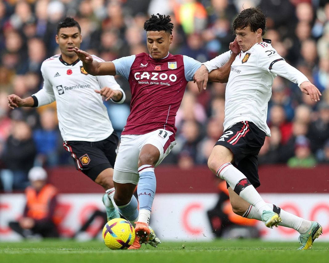 Ollie Watkins Surrounded By Opposing Team Wallpaper