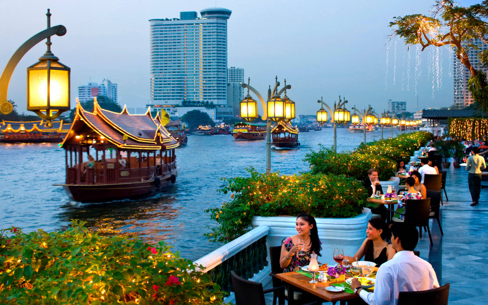 People Having Dinner Along The Riverside Wallpaper