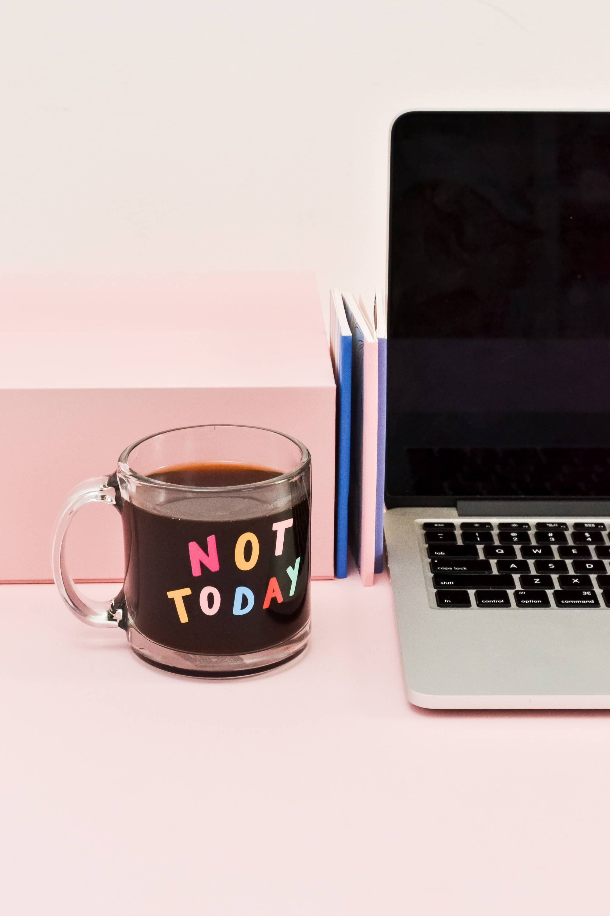 Personal Workspace Featuring A Laptop And A Cup Of Coffee With A 'not Today' Etching. Wallpaper