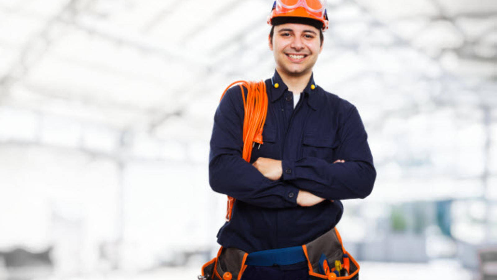 Professional Electrician Smiling At Work Wallpaper