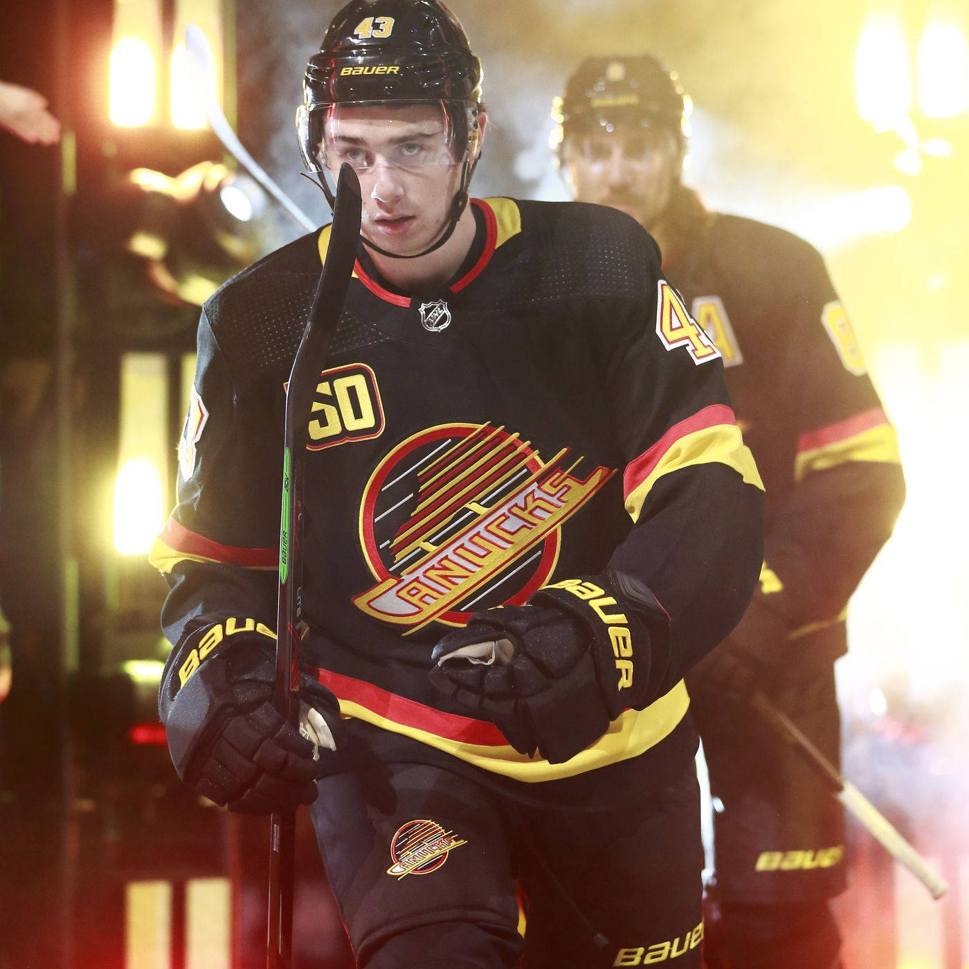 Quinn Hughes In Retro Black Jersey During Game Opening Wallpaper