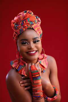 Radiant Nigerian Woman Adorned In Colorful Ornaments Wallpaper