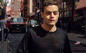 Rami Malek Pose On Busy Street Wallpaper