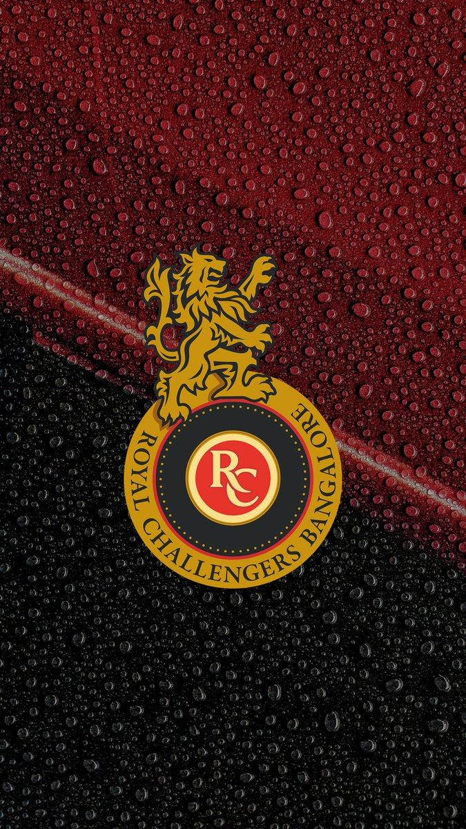 Rcb Team Logo On Wet Surface Wallpaper