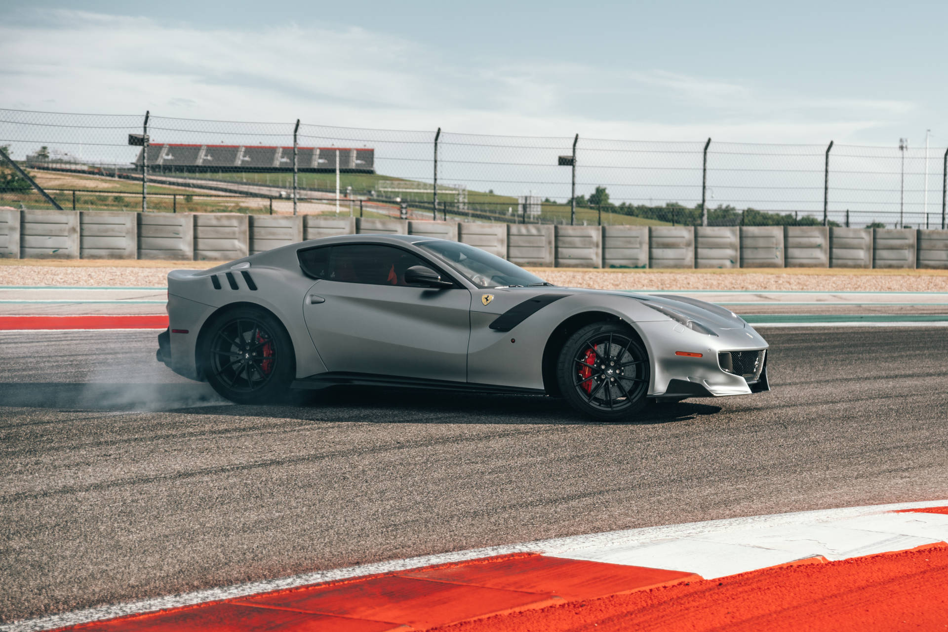 Reach Your Top Speed On The Track With The Silver Ferrari Wallpaper