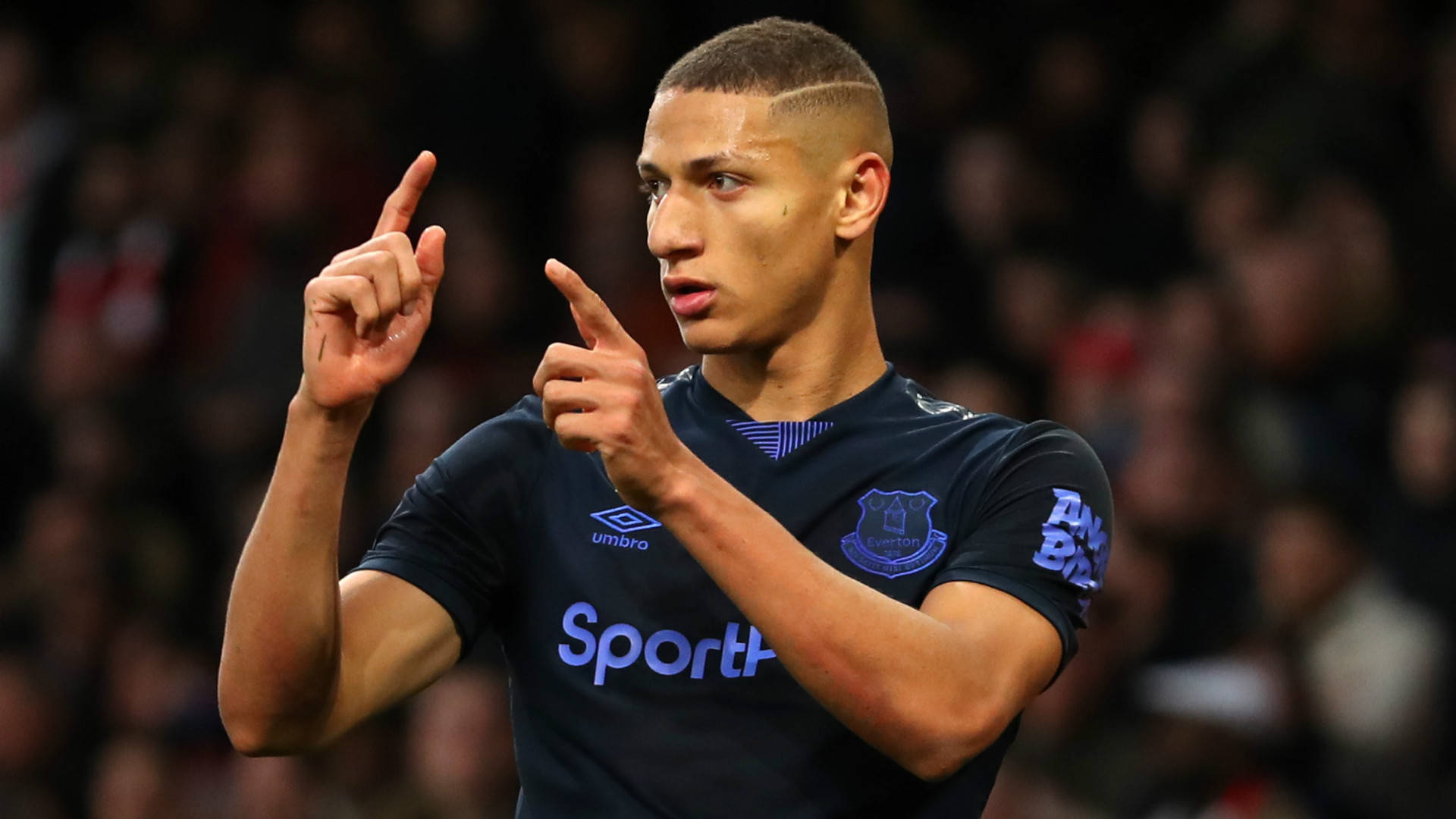 Richarlison De Andrade Performing His Iconic Finger Gun Celebration On The Soccer Field Wallpaper