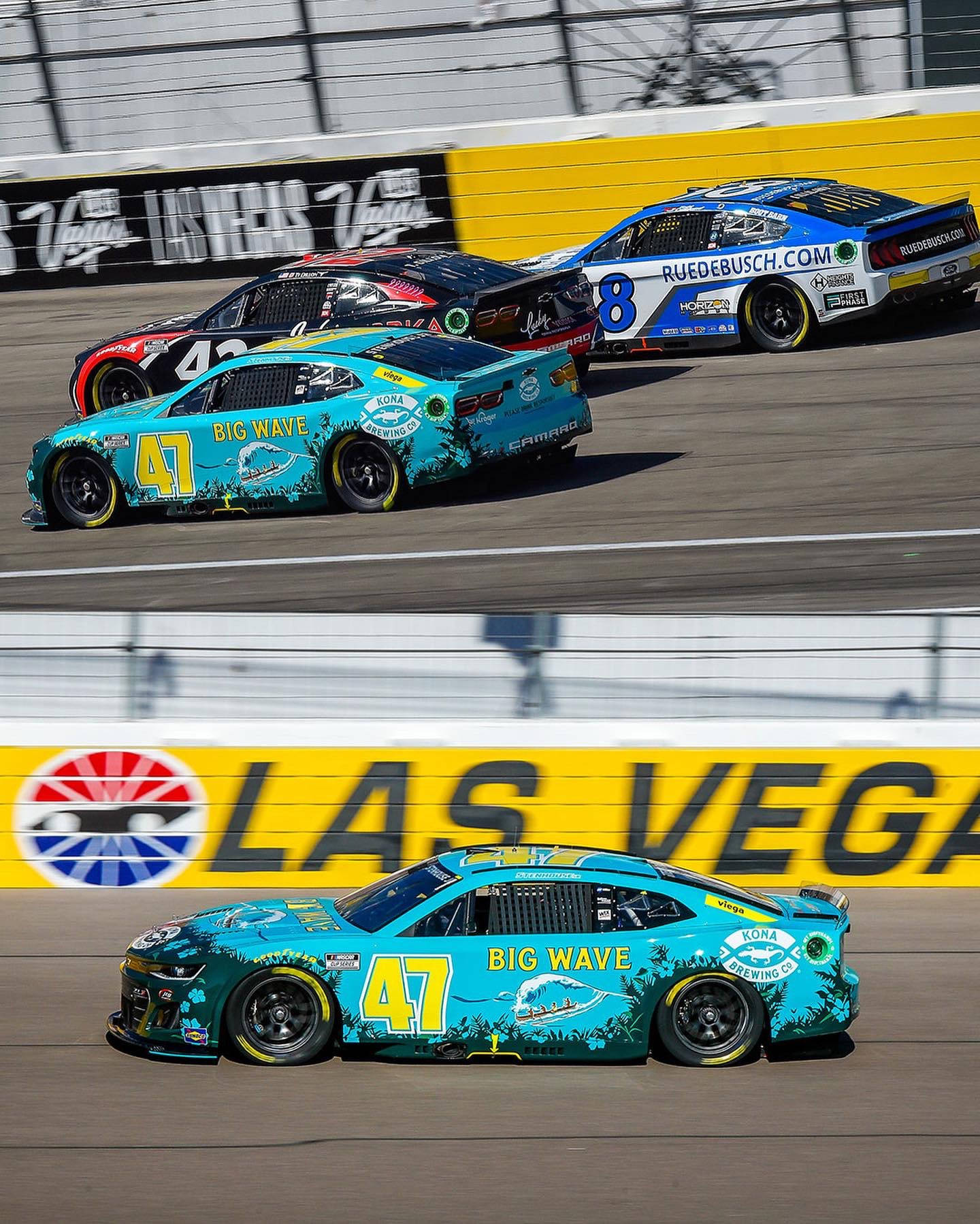 Ricky Stenhouse Jr., In His Dazzling Blue Racing Car, Vying For A Position On The Race Track. Wallpaper