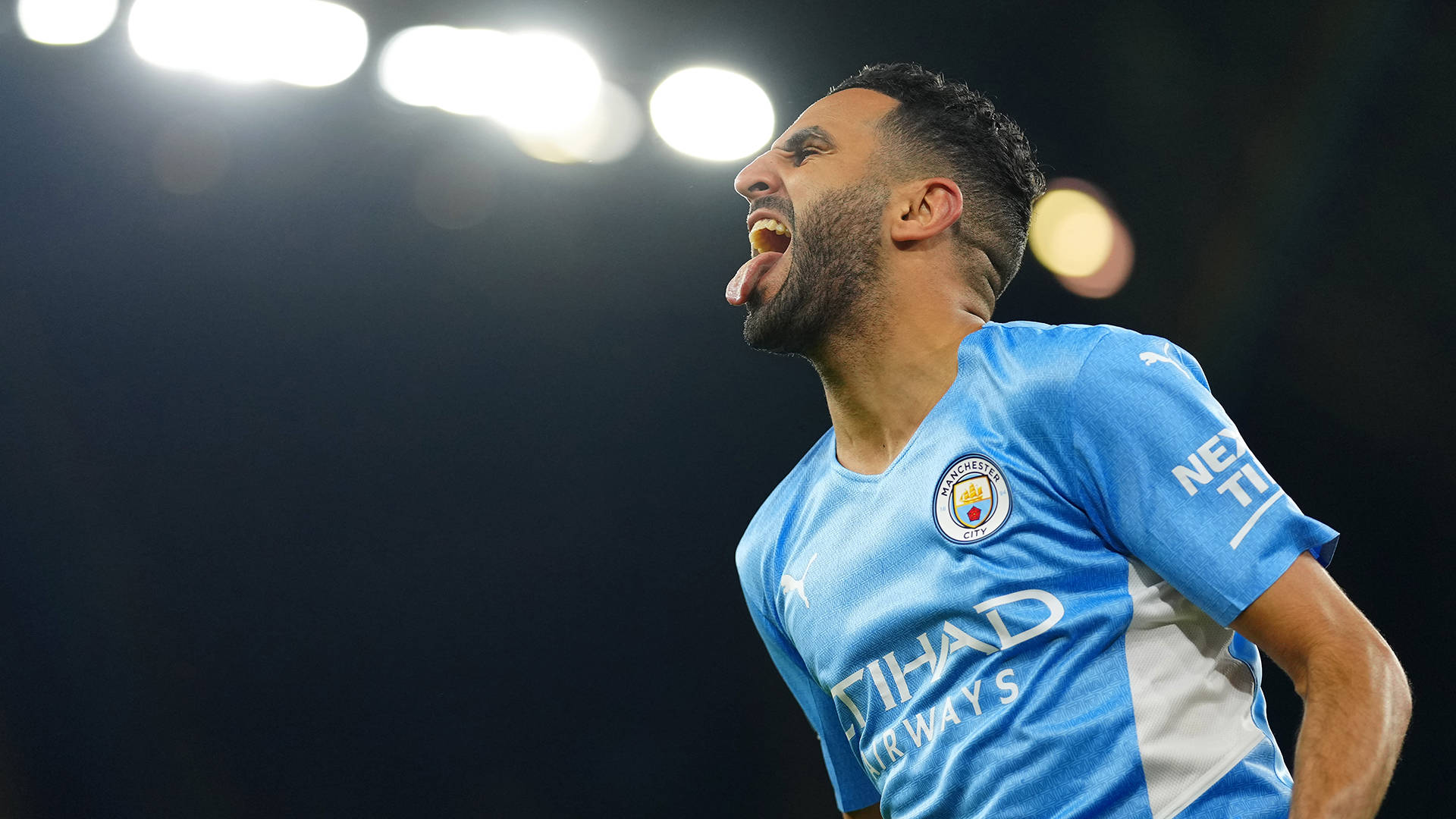 Riyad Mahrez Tongue Out Lights Wallpaper