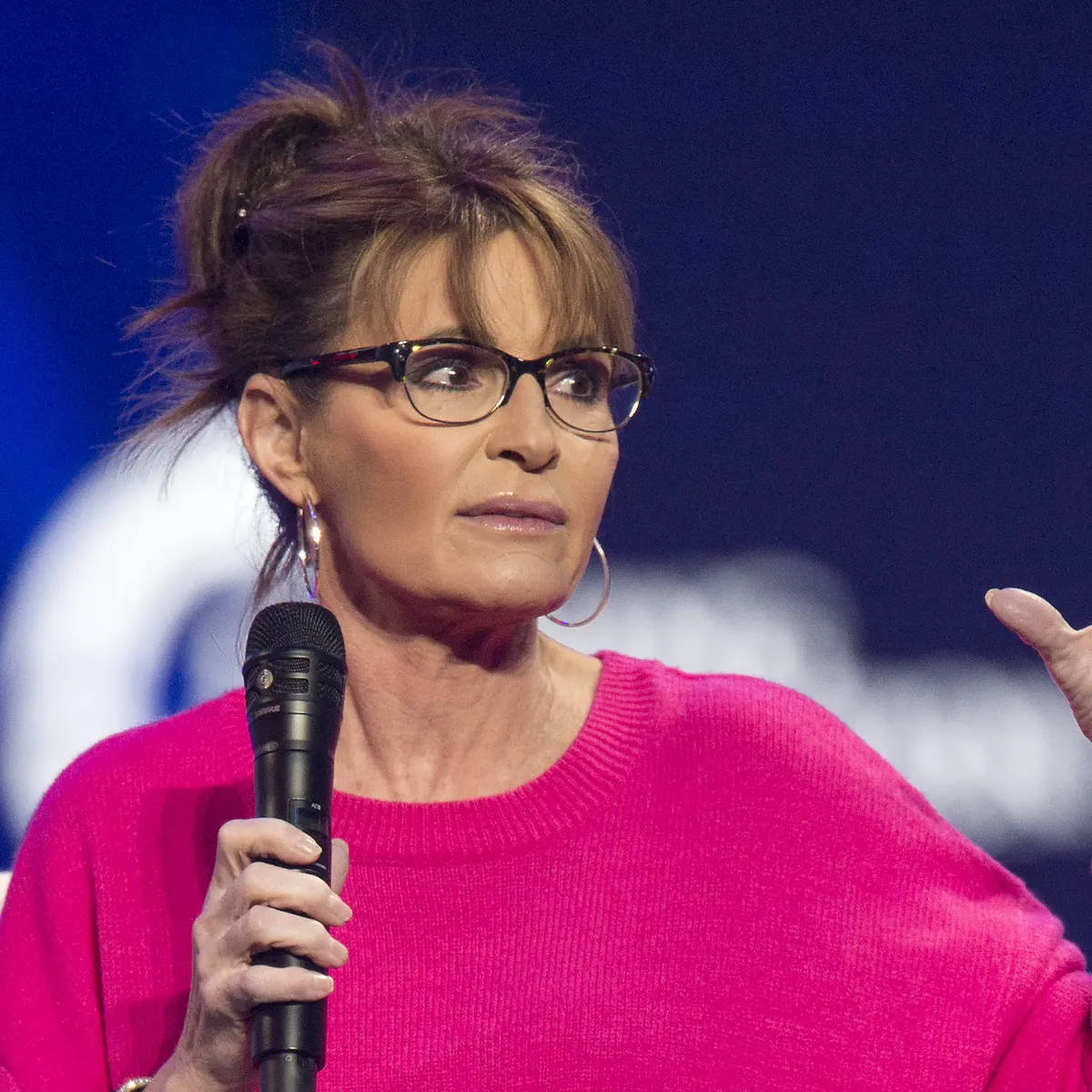 Sarah Palin Posing In A Pink Sweater Wallpaper