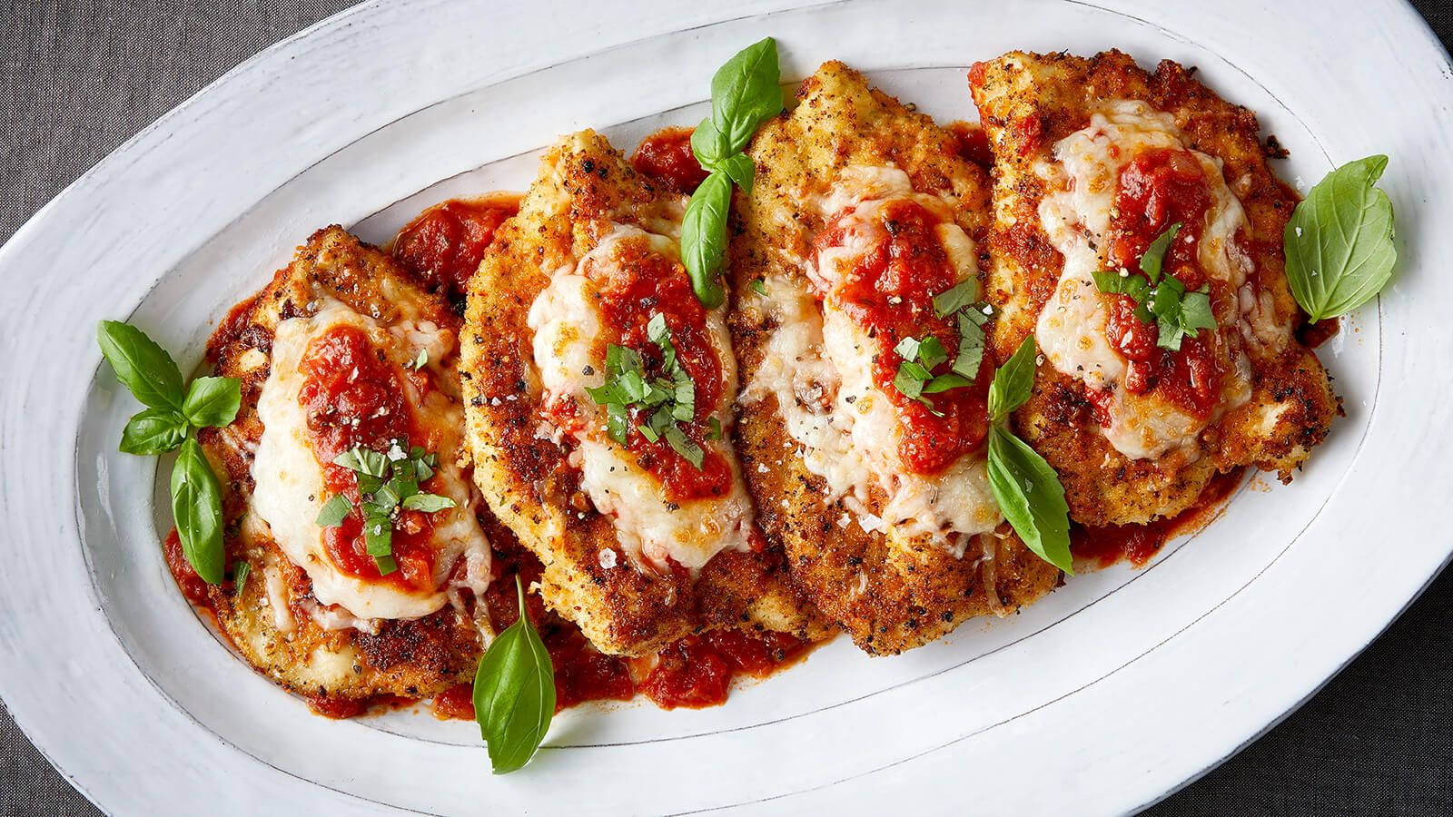 Savory Chicken Parmigiana Freshly Cooked To A Golden Crisp Wallpaper