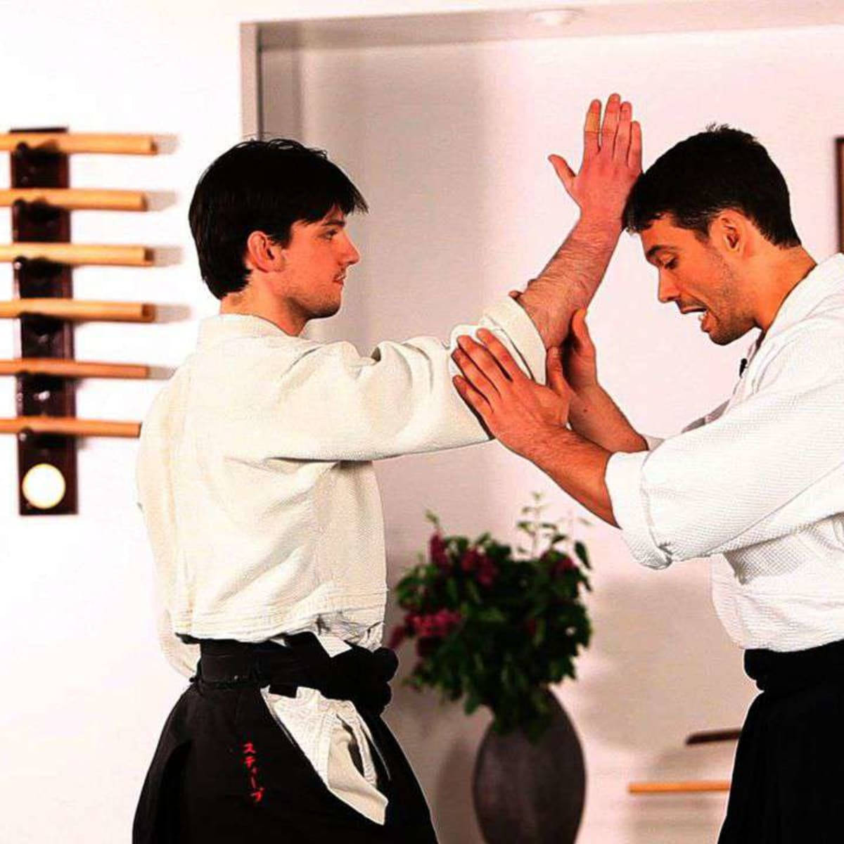 Sensei Demonstrating Nikyo Technique In Traditional Aikido Class Wallpaper