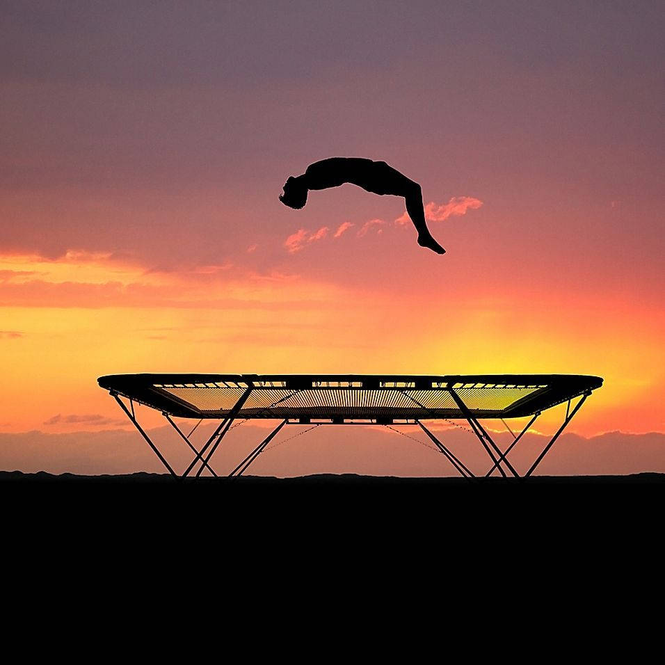 Silhouetted Man And A Trampoline Wallpaper