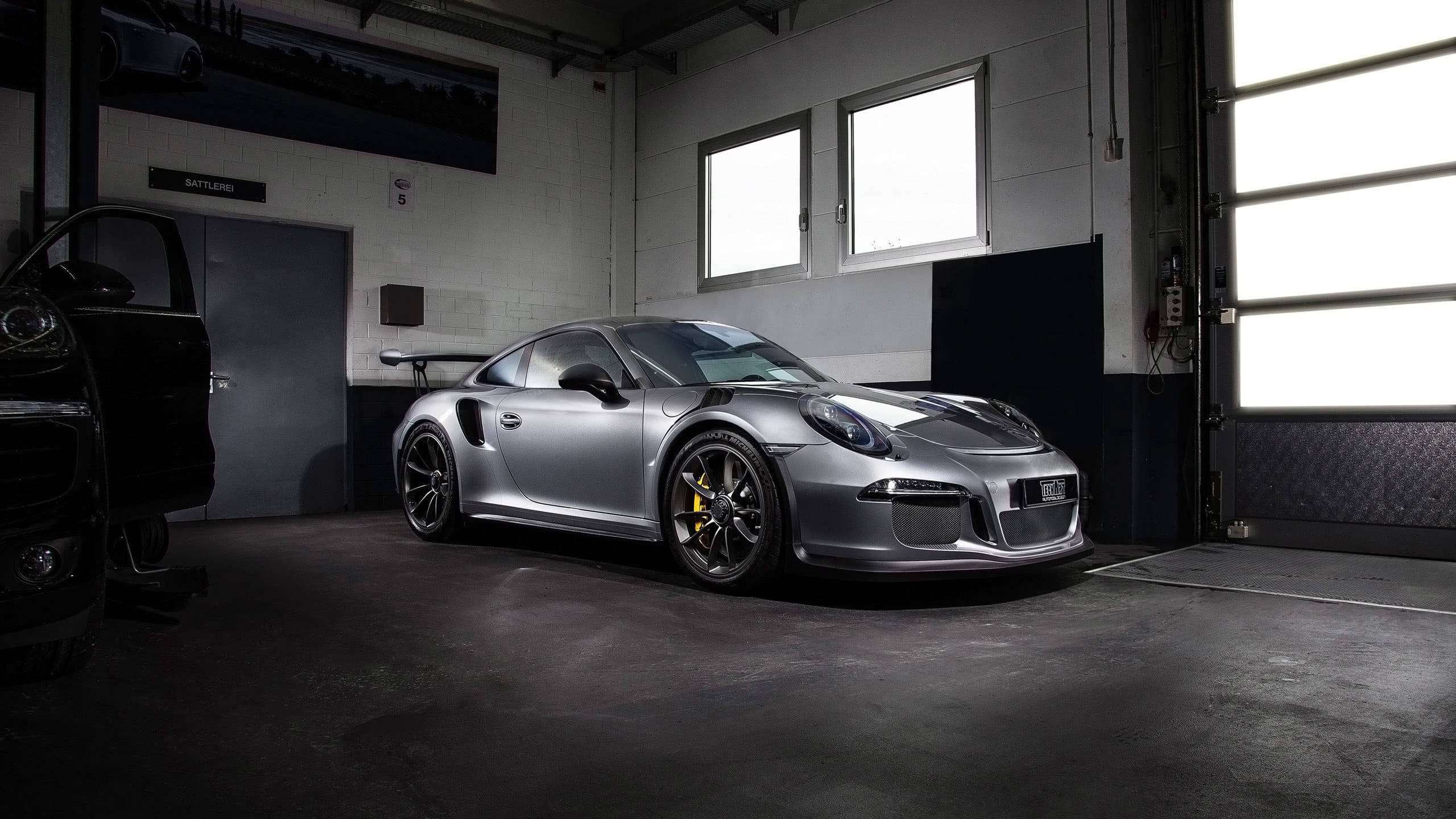 Silver Porsche 911 Parked In Garage Wallpaper