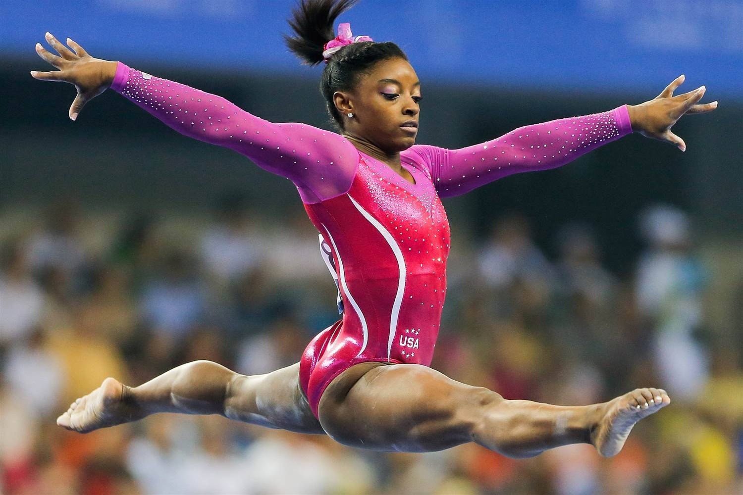 Simone Biles Performing A Perfect Balance Beam Routine Wallpaper