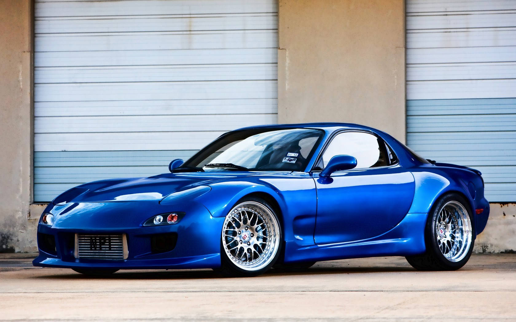 Sleek Blue Rx7 Car Parked Wallpaper