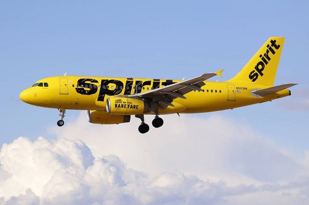 Spirit Airlines Yellow Plane On Clouds Wallpaper