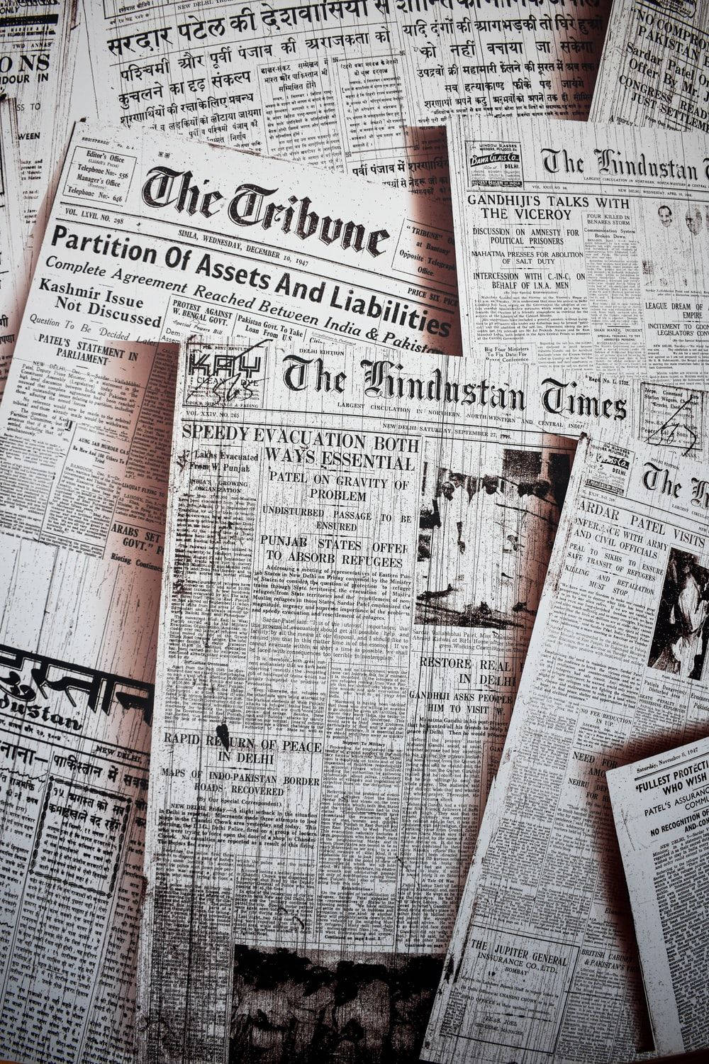 Stack Of Aged Newspapers In Monochrome Wallpaper