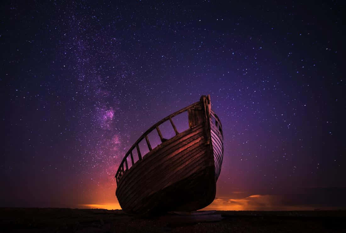 Starry Night Over Abandoned Boat Wallpaper