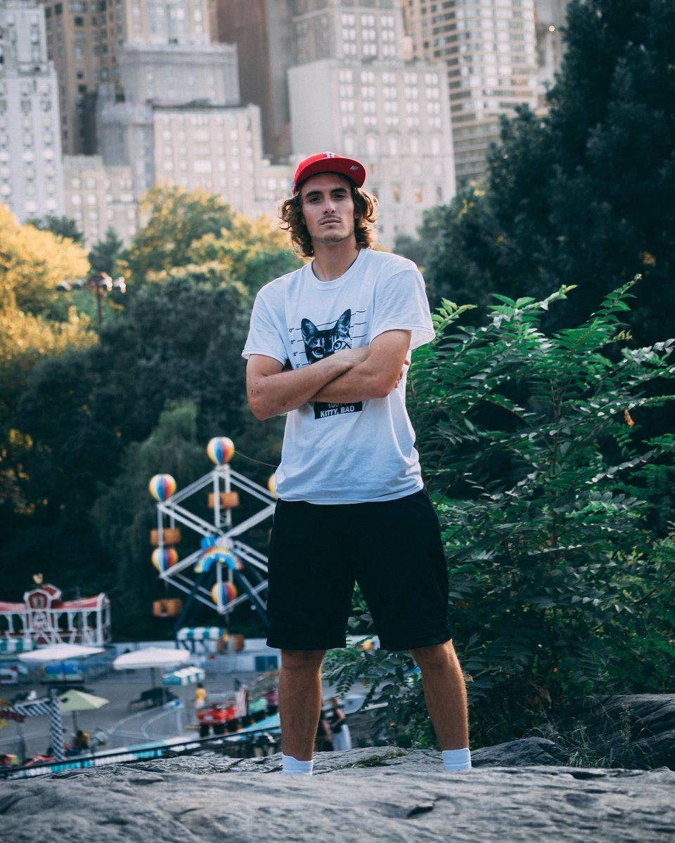 Stefanos Tsitsipas At An Amusment Park Wallpaper