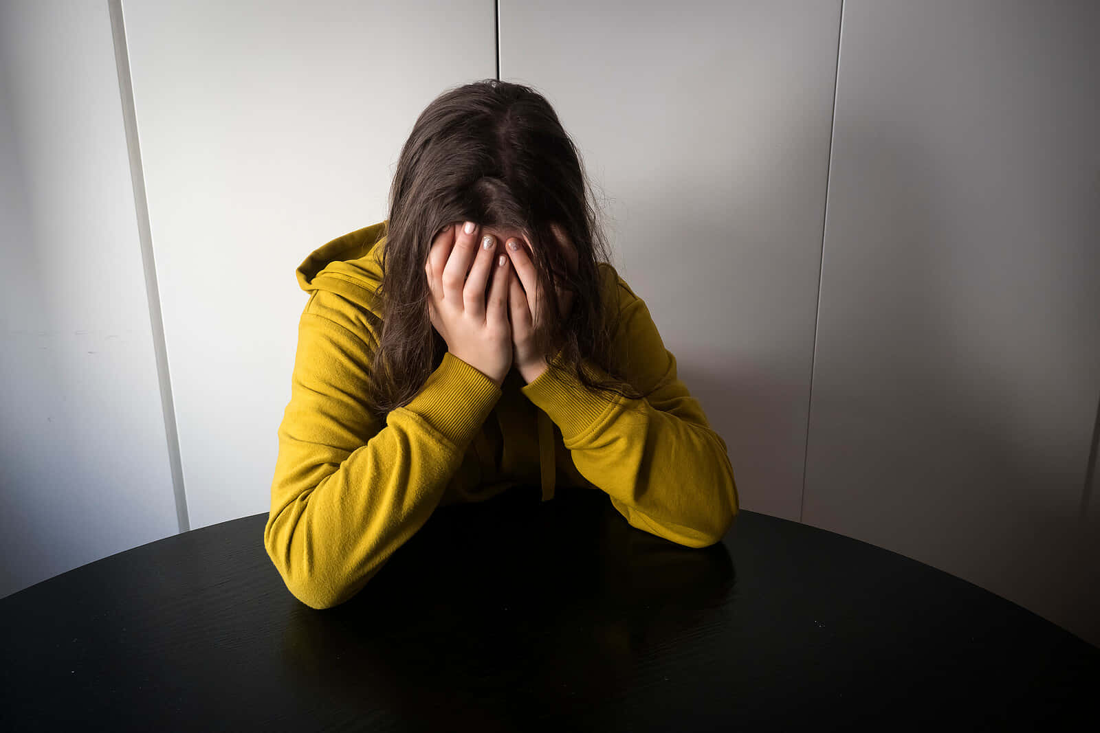 Stressed Person Covering Face Wallpaper