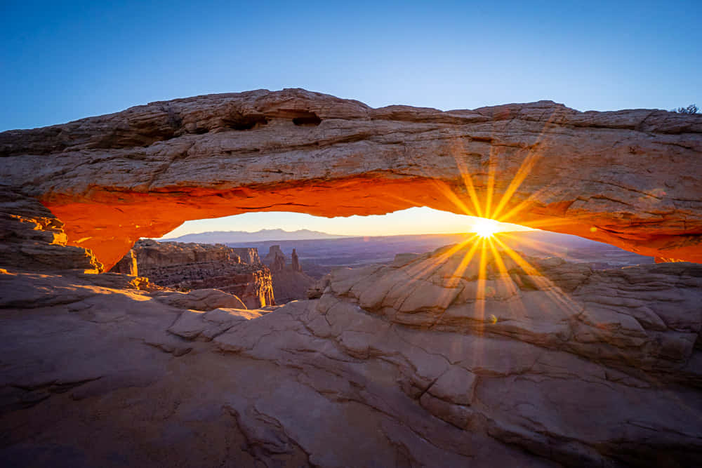 Sun Peeking Under Delicate Arch Wallpaper