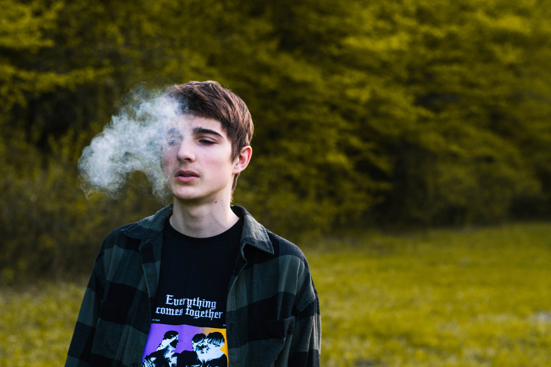 Teenage Guy Smoking In Park Wallpaper