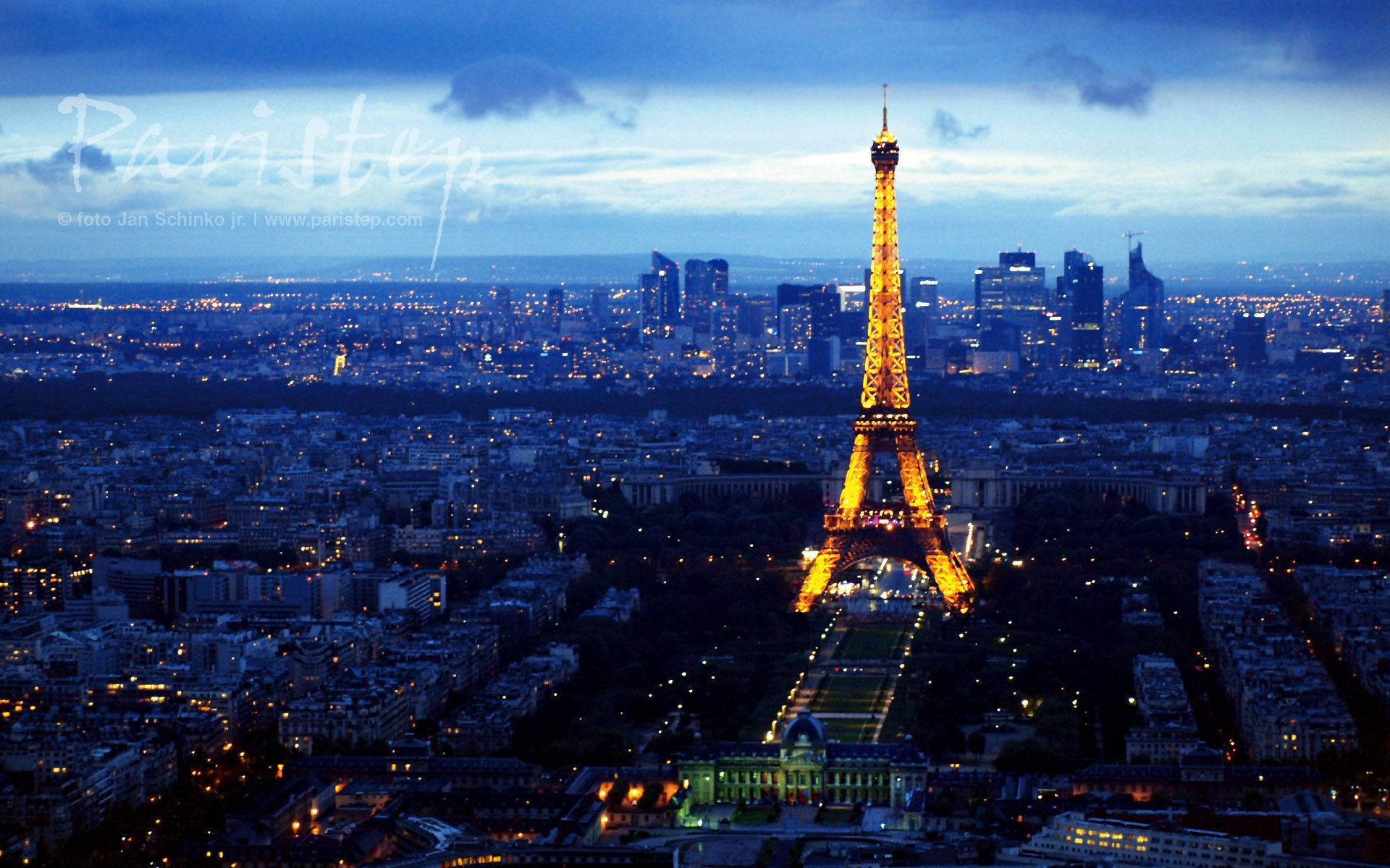 The Eiffel Tower Illuminated In Golden Light In Paris Wallpaper