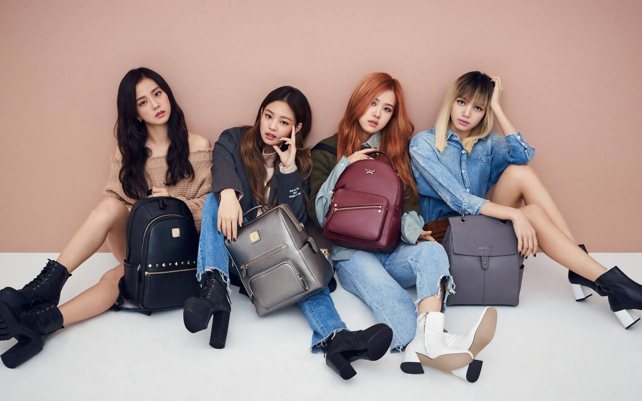 The Four Blackpink Members Carrying Their Backpacks In Style. Wallpaper