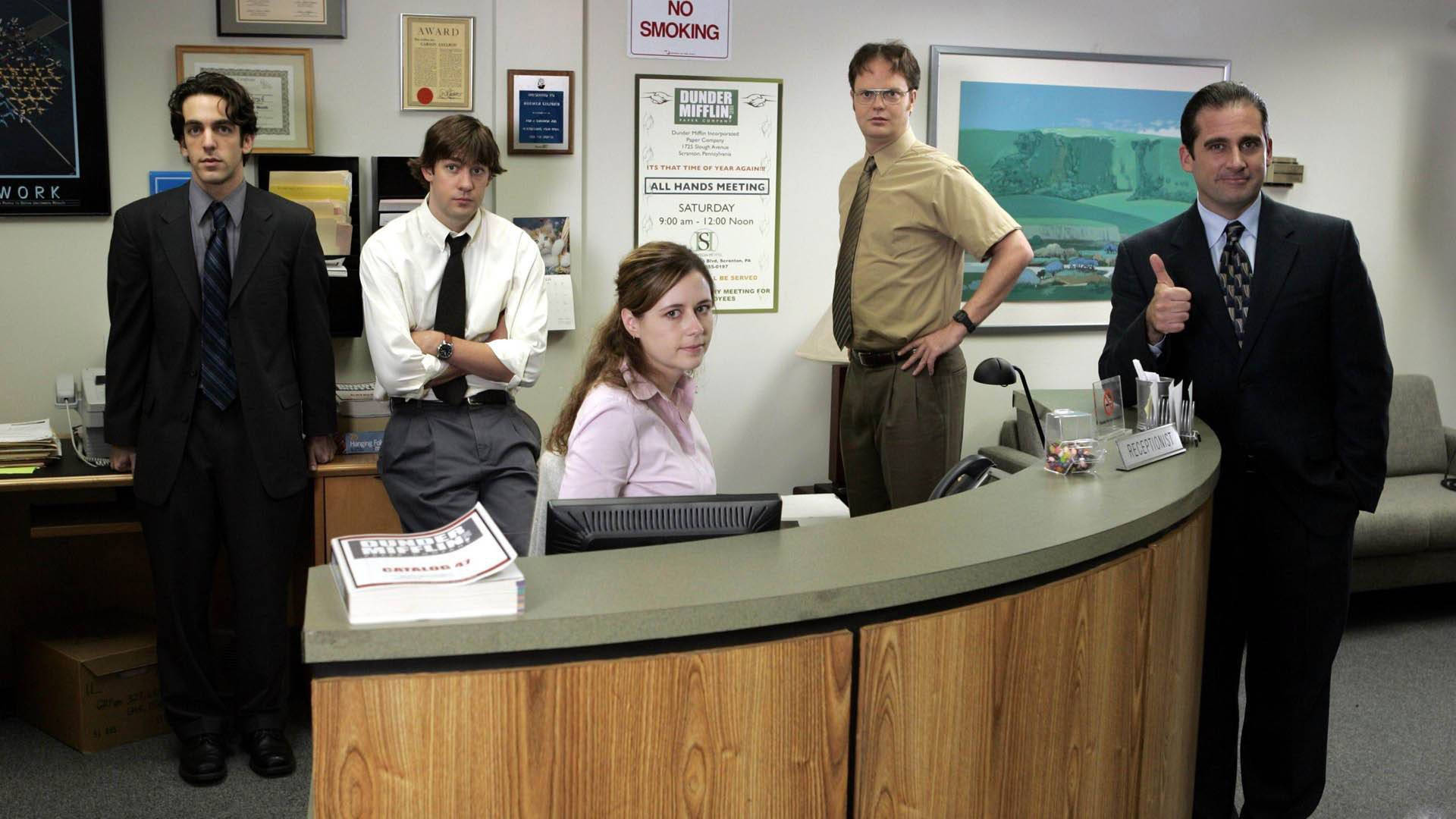 The Office Cast At Dunder Mifflin's Reception Desk Wallpaper