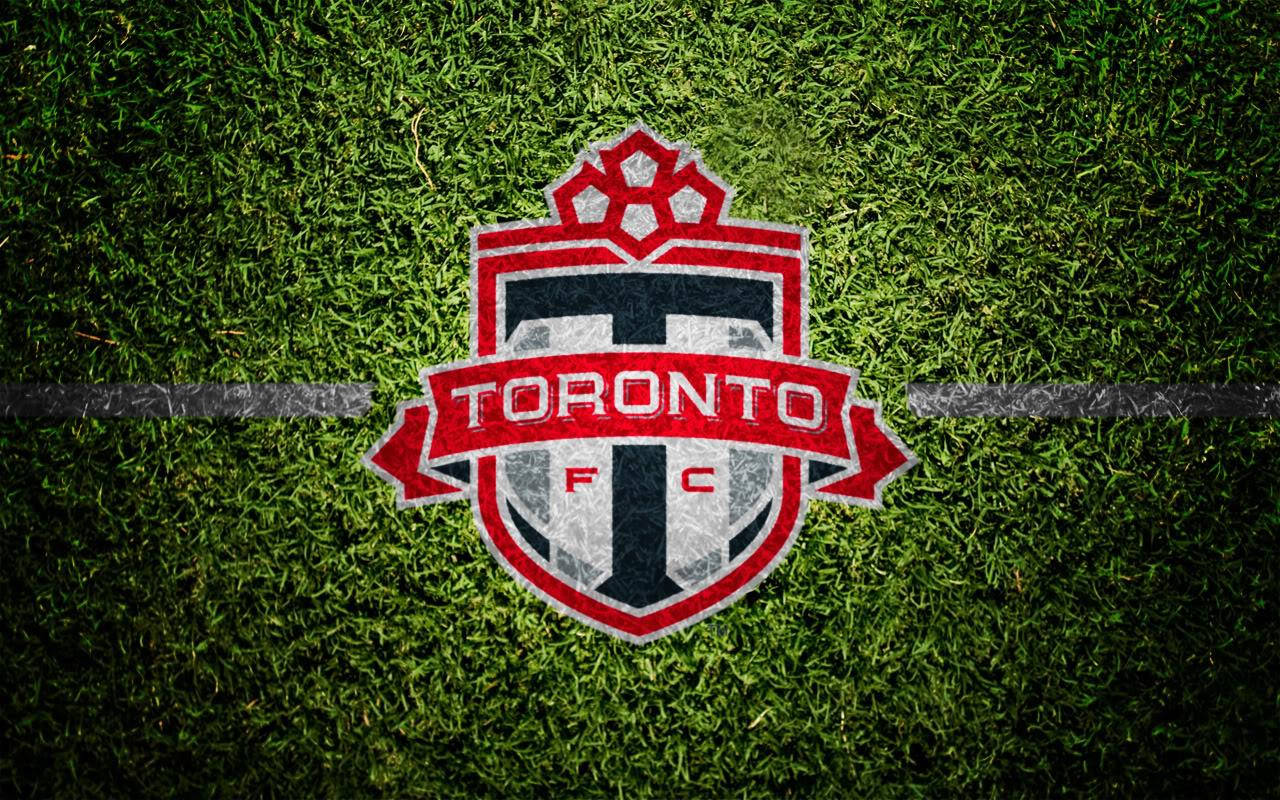 The Official Logo Of Toronto Fc Emblazoned In Vibrant Red. Wallpaper