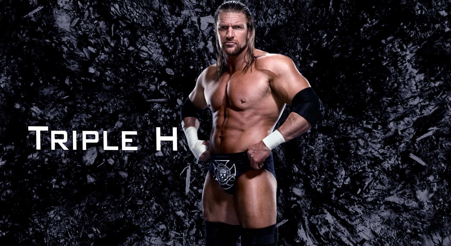 Triple H Posing Against Black Uneven Surface Wallpaper