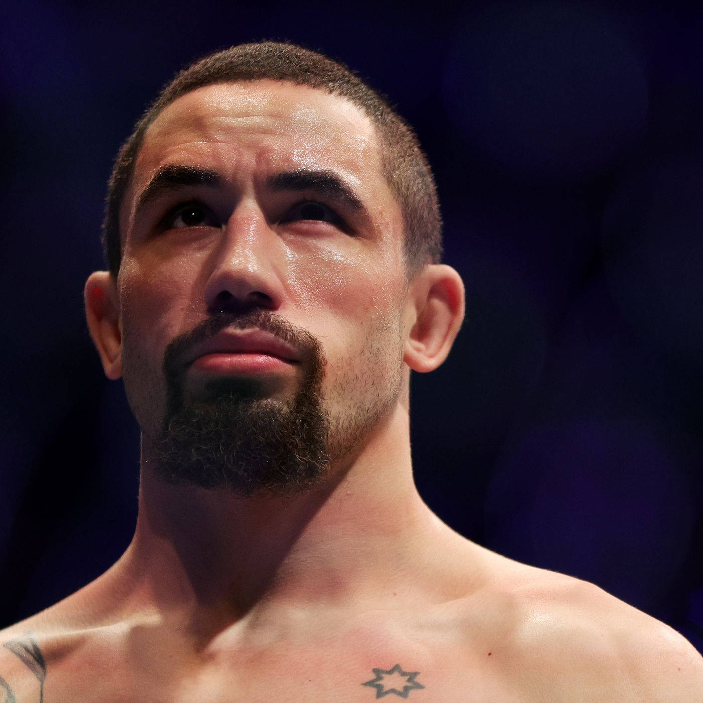 Ufc Fighter Robert Whittaker Posing Against A Black Backdrop Wallpaper